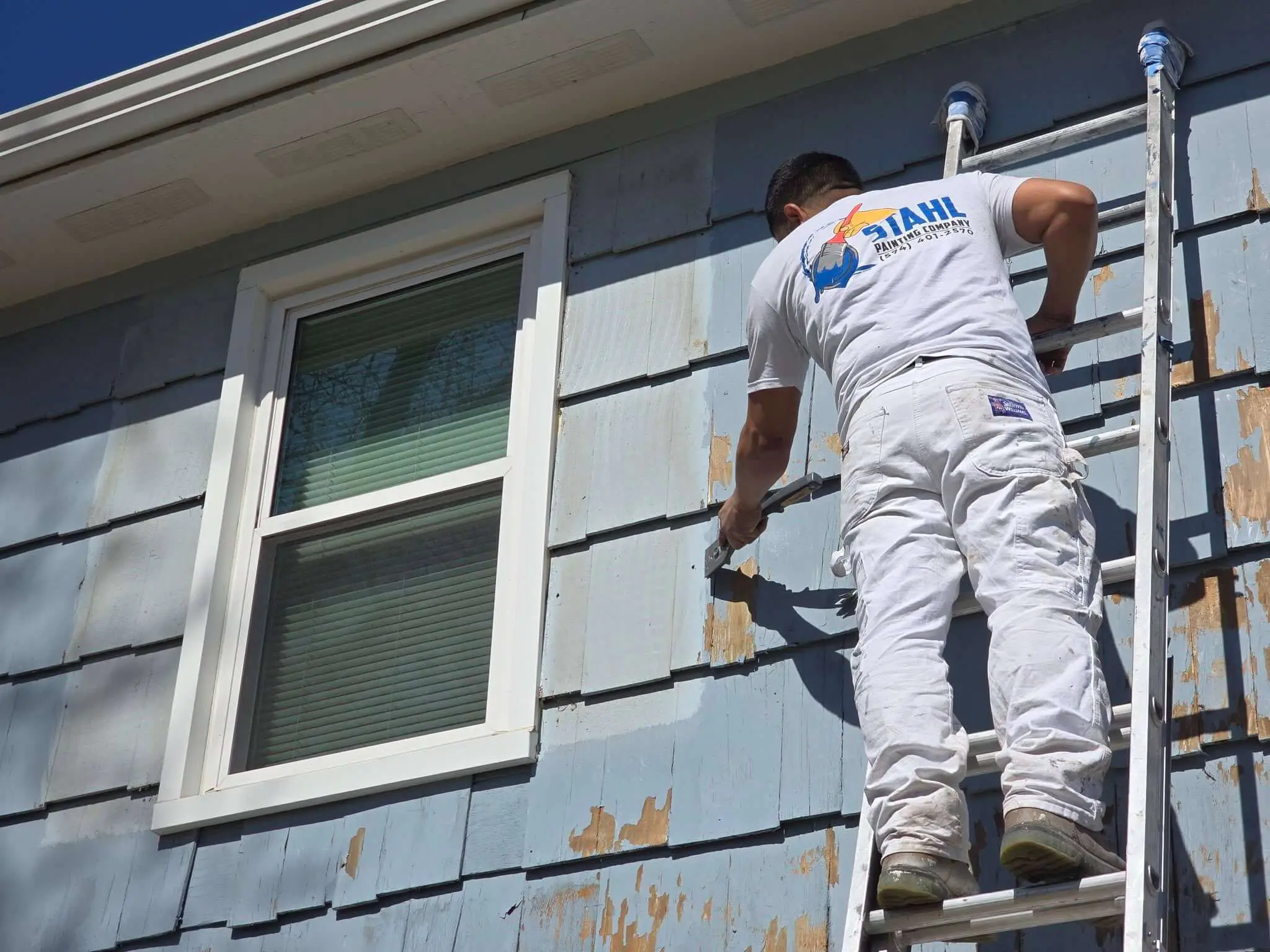 Stahl Painting Company’s expert crew performing residential exterior painting, utilizing spray application for a smooth, high-quality finish.