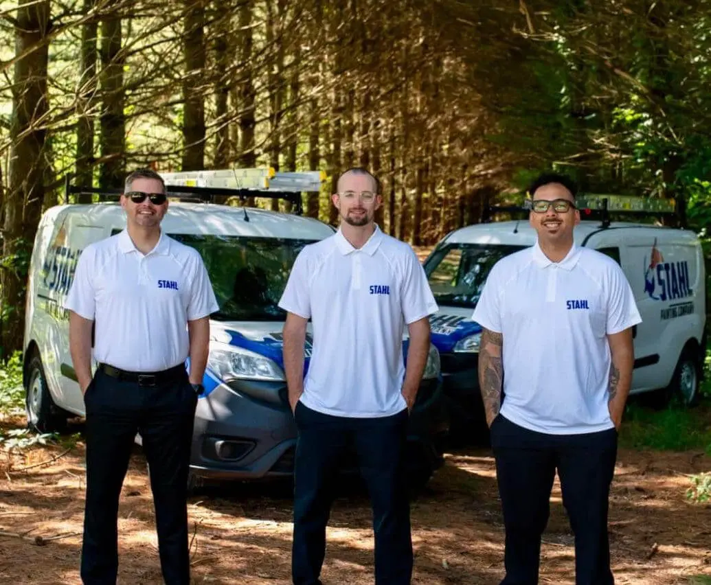 michiana painters stahl painting team standing in front of branded vehicles