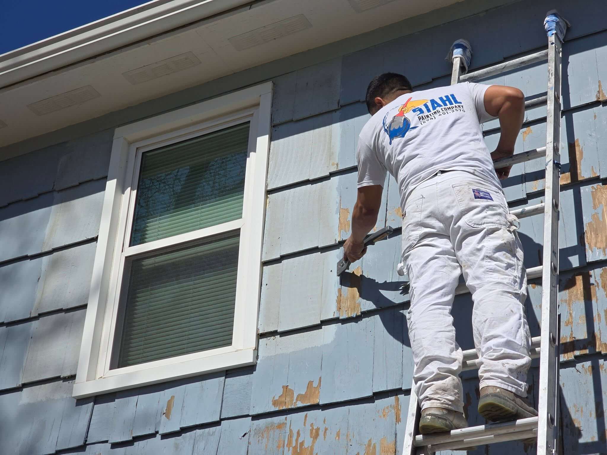 Stahl Painting Company’s expert crew performing residential exterior painting, utilizing spray application for a smooth, high-quality finish.