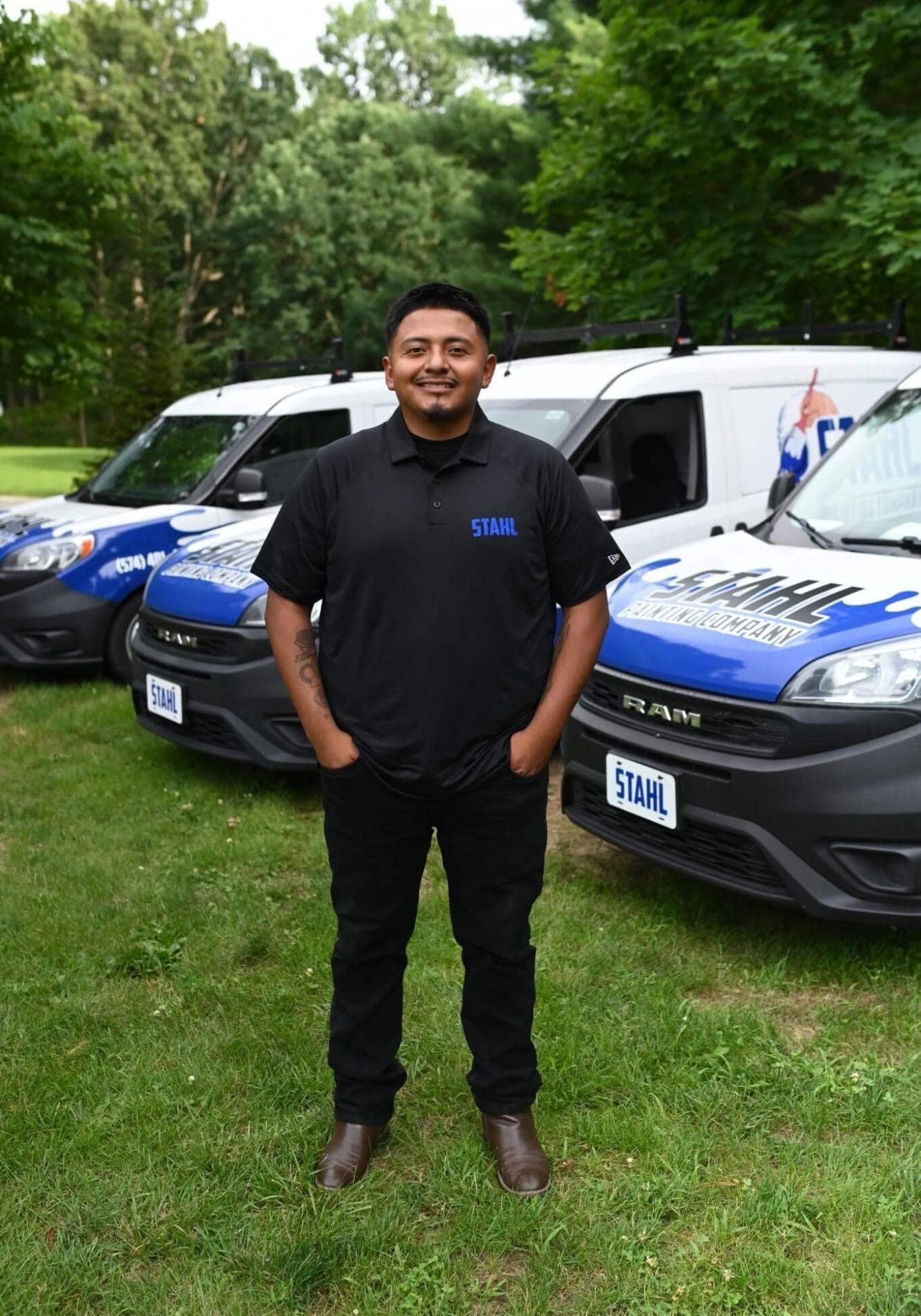 stahl painting house painter standing in front of branded vehicles