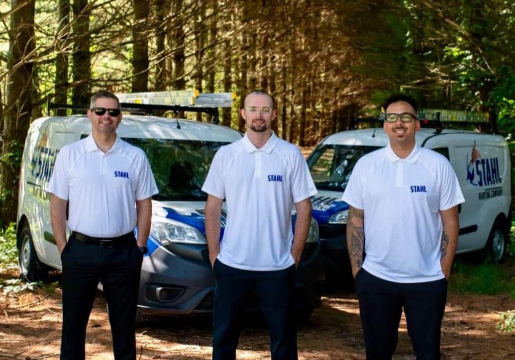 michiana painters stahl painting team standing in front of branded vehicles