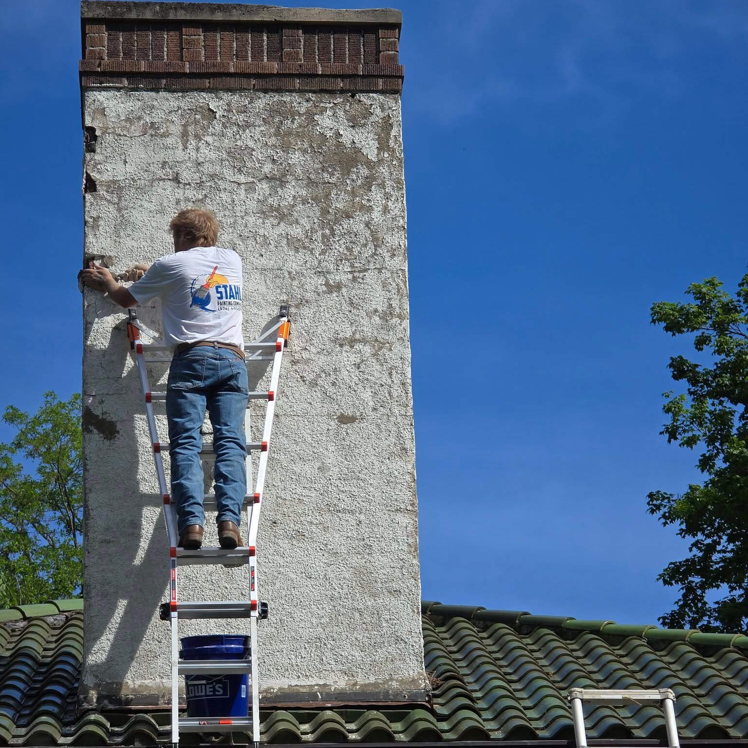 Stahl Painting Company's skilled team performing detailed exterior masonry and trim painting on a residential property.